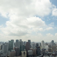 大きな白い雲と梅田の高層ビル群の青空都市景観の写真