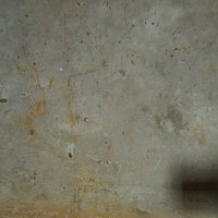 錆と細かい傷が残る経年劣化したコンクリート床の写真