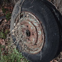 機関庫跡に不法投棄された錆びた車輪とタイヤの写真