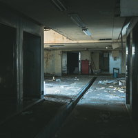 光が差し込む廃墟の室内 - ボロボロに崩れた壁と瓦礫が散乱の写真