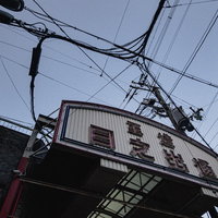 玉造日之出通商店街の路地に立つ白い看板と街並みの写真