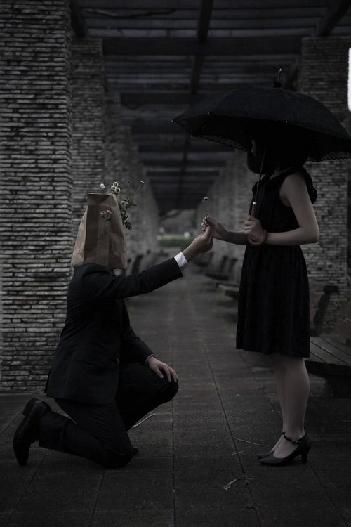 大切なお花を手渡す異色の恋、日傘を持つ女性へのプロポーズ