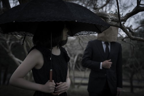 紙袋と日傘で顔を隠し女性をつき纏う予告犯