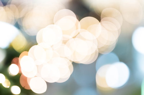 イルミネーションの連なる丸ボケ、暖色の光が輝く夜景背景