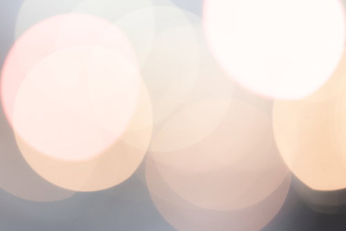 イルミネーションのオークル色の丸ボケ背景
