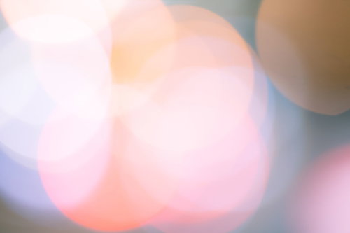 ピンクとオレンジの色あせた丸ボケ背景