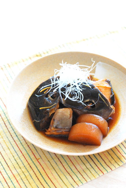 白い器に盛り付けたぶりのあら煮と大根人参の煮込み