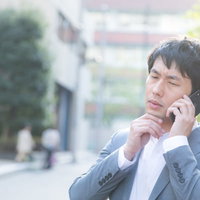 担当の作家と電話がつながらない会社員男性の写真