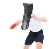 黒子姿で卓球のサーブを打つ男性の写真