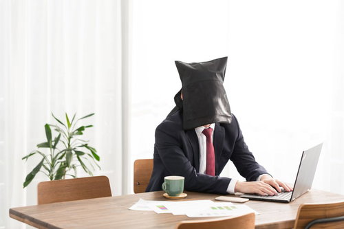 資料にコーヒーをこぼす3秒前、顔を隠したノマドワーカー