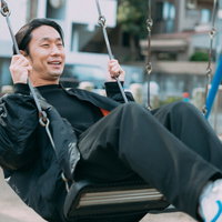 フリー素材モデル10年選手の男性がブランコで笑顔の写真