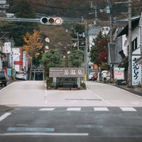 岳温泉のヒマラヤ大通りと信号機、温泉旅館の看板が並ぶ秋の温泉街の写真
