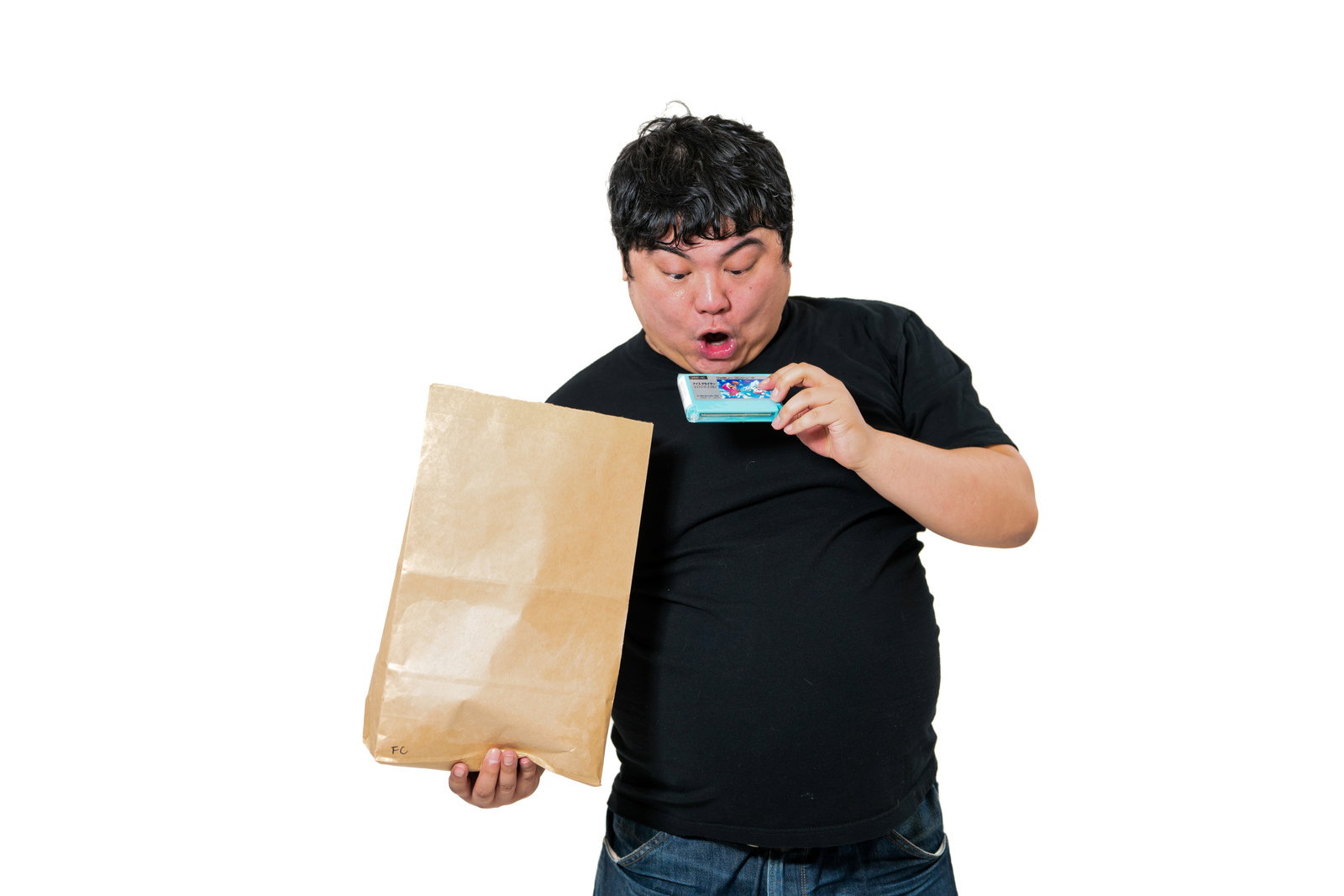 A man surprised to find a NES cartridge in a brown paper bag
