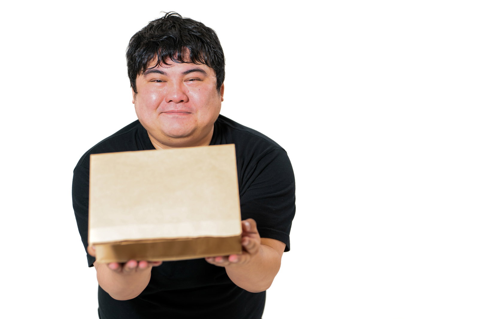 A man holding a cardboard box with a smile