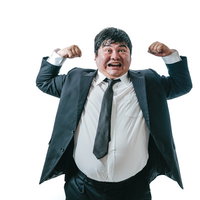 マッスルポーズで威張る会社員の勝気な表情の写真
