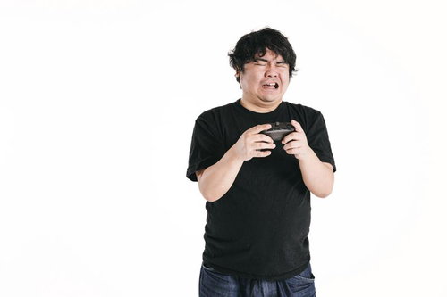 ゲームコントローラーを握りしめ失望の表情を浮かべる男性