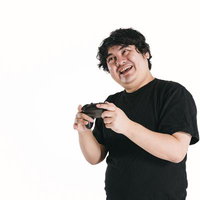 ゲームのクライマックスに笑顔が止まらないゲーマー男性の写真