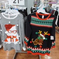店頭に並ぶ派手なクリスマスダサセーター、雪だるまとトナカイのデザインの写真