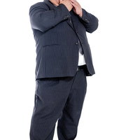 はち切れそうなストライプスーツを着て驚く膨よかな男性の写真