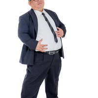 お腹周りの贅肉を気にするネイビーストライプスーツの会社員男性の写真