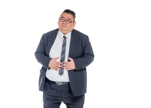 お腹を押さえる膨よかな男性スーツ姿の腹痛表現