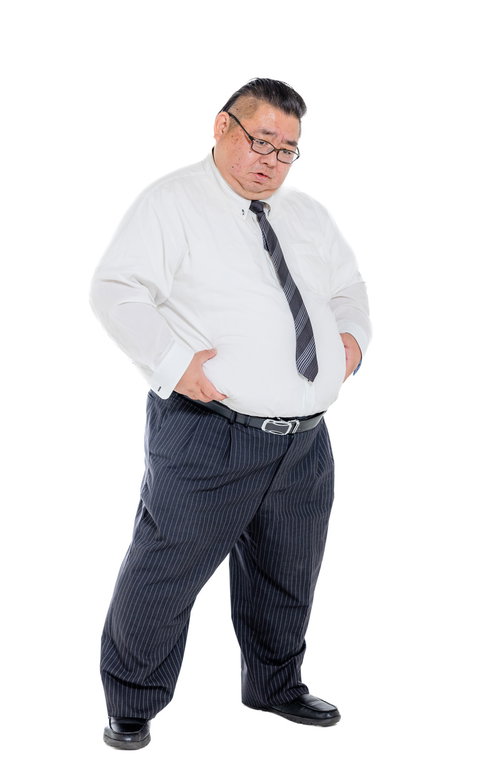 お腹周りに付いた皮下脂肪を掴む膨よかな男性会社員