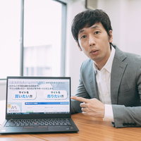 副業でドメイン売買について説明するスーツ姿の男性の写真