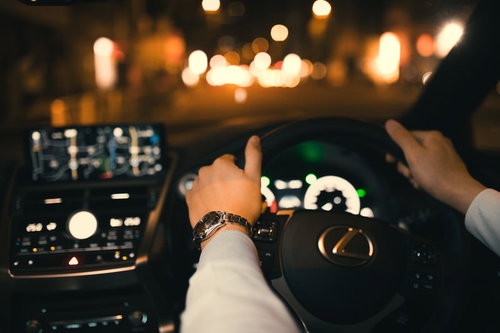 銀座の夜に走るタクシーと時計塔のある交差点