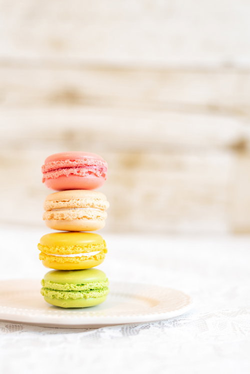 白いお皿に積み重ねられた一番上がピンクのマカロン