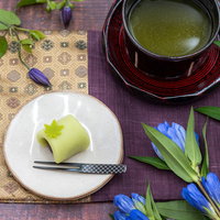おやつで出されたお茶と練り切りの和菓子、白い皿と茶碗の写真