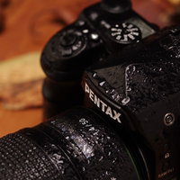 雨にびしょびしょに濡れたPENTAX K-1MarkⅡのロゴの写真