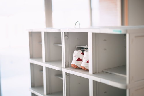 ふたば未来学園の下駄箱に並ぶ白と赤のシューズ