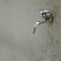 元大野小学校に残る水道蛇口、青いレバーハンドルと錆の痕跡の写真