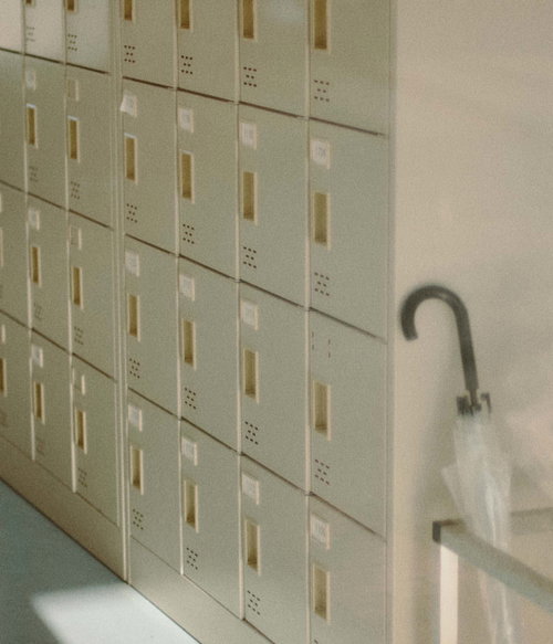 ふたば未来学園の下駄箱と傘立てに掛かる白い傘