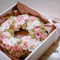 ピンク系の生花を使ったボックスフラワー型リースの写真