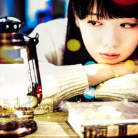 ランタンを見つめる文学美女、洋書に囲まれて（フォトモンタージュ）の写真