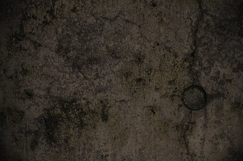 薄暗いグレーのコンクリート壁テクスチャー