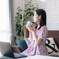 空いた時間でコーヒーを飲みながら在宅ワークの写真