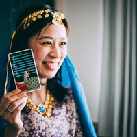 笑顔でソードの9を選ぶ占い師のタロット占いの写真