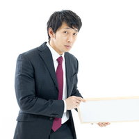 正解を発表しない司会者がフリップボードを持つの写真
