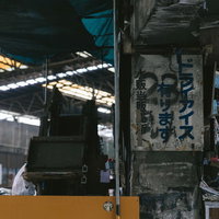 築地市場内の風化した古い看板、コンクリート壁の劣化した表面の写真