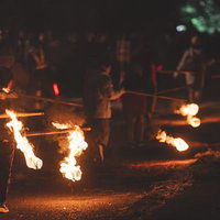 松明持つ行列に揺れる炎の写真