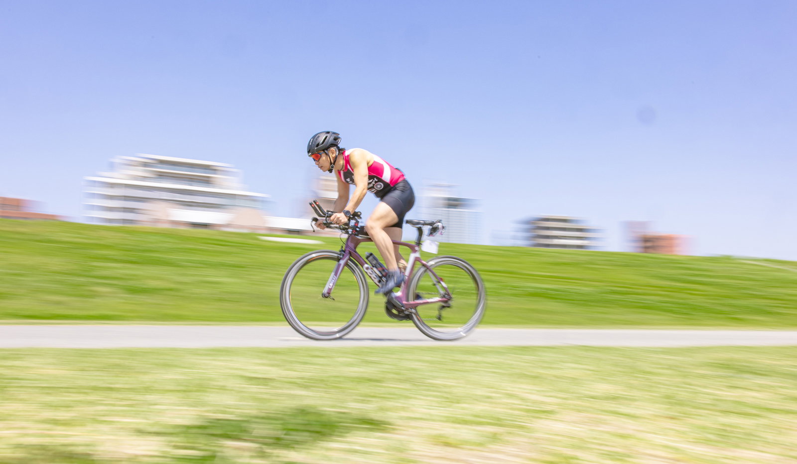 トライアスロン競技で自転車を駆る男性選手のスピード感ある走行シーン［モデル：うえせい］
