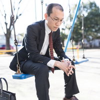 会社に戻るのが嫌だと項垂れるスーツ姿の男性の写真