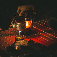 ソロキャンプの夜、シングルバーナーにやかんをのせるの写真