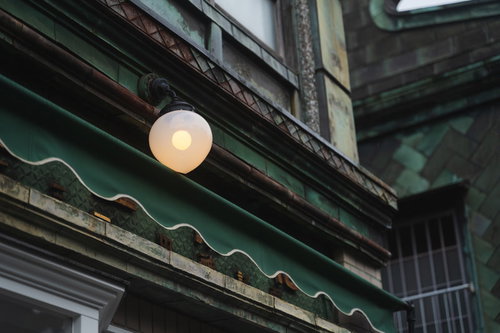 日中に灯る緑色の建物のアンティーク屋外照明