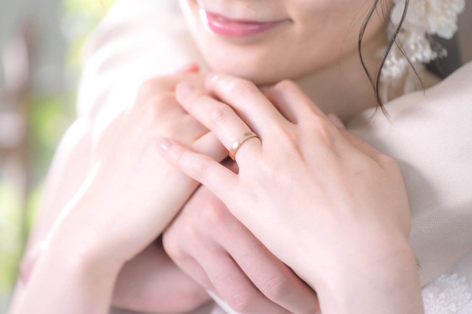 白いウェディングドレスを着て後ろから抱きしめられる女性［モデル：たけべともこ］