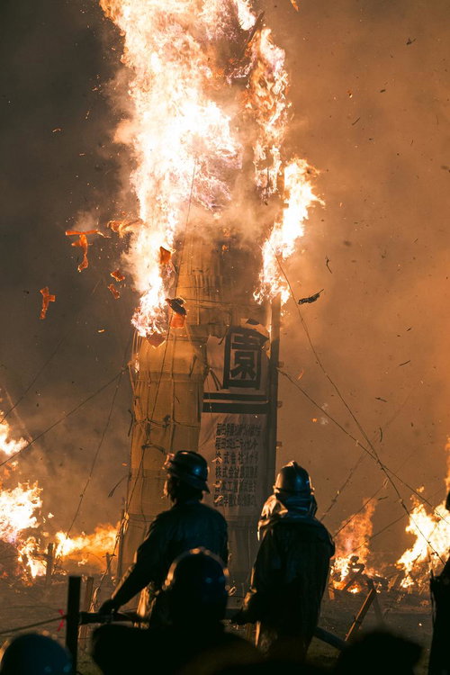 松明あかしで大松明の火柱を見守る青年団の前線