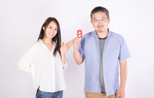 ヘルプマークを掲げて啓蒙する男性と女性による障害者支援の表現