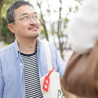 席を譲ってもらったヘルプマーク所持者の男性が見せる笑顔の写真